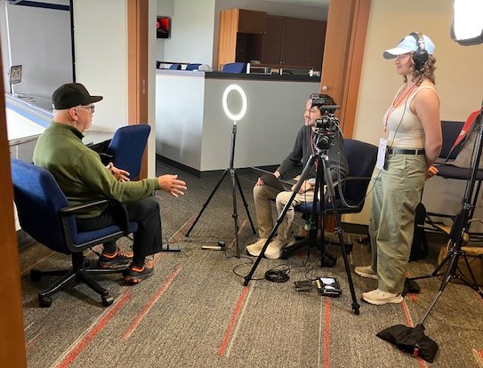 Students interview MLB broadcaster Jon Miller.