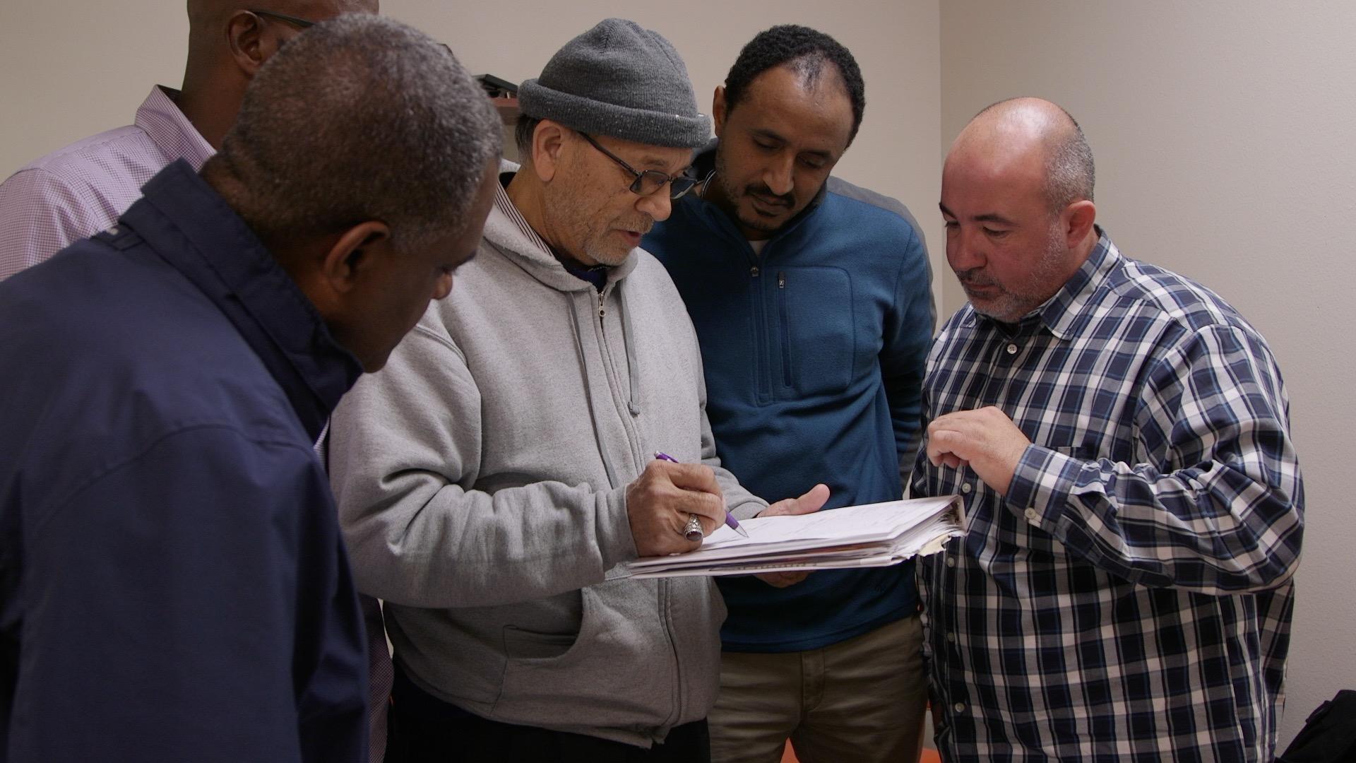 Still image of taxi drivers featured in "One Driver, One Mic"