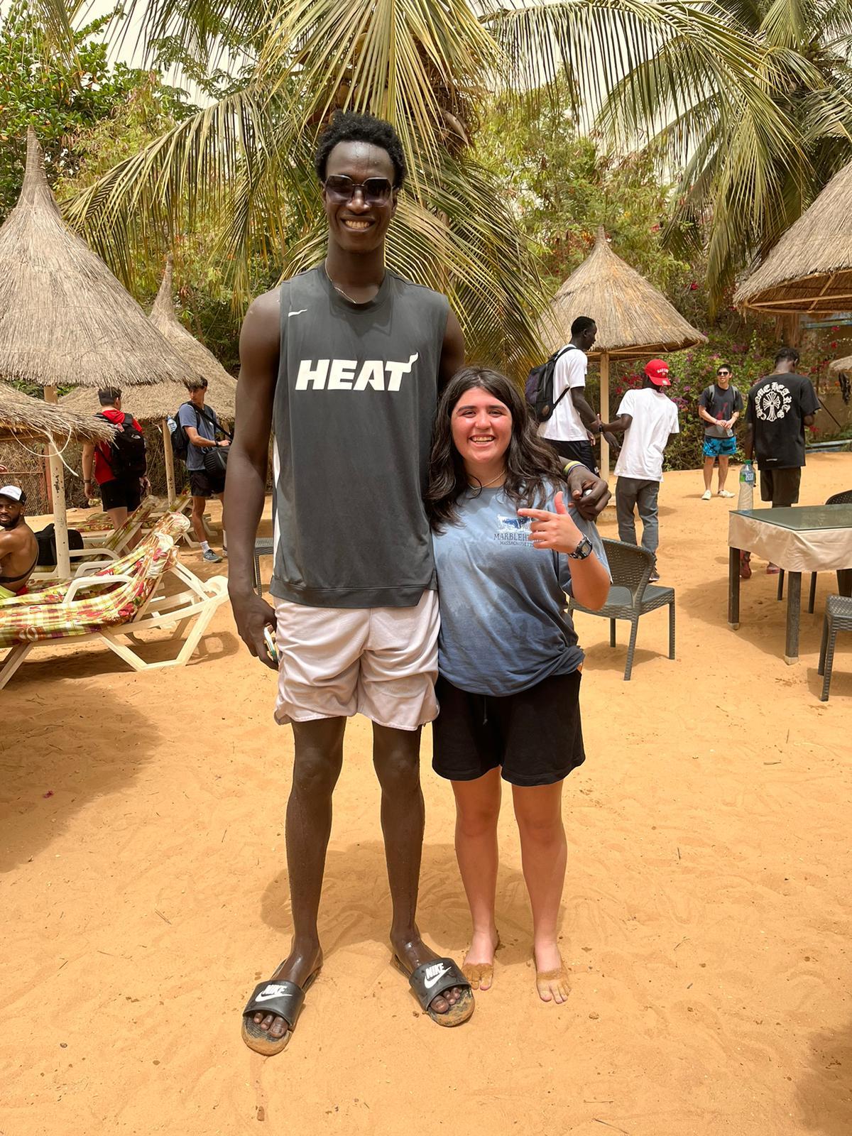 Jenna Bloom with a basketball player in Africa