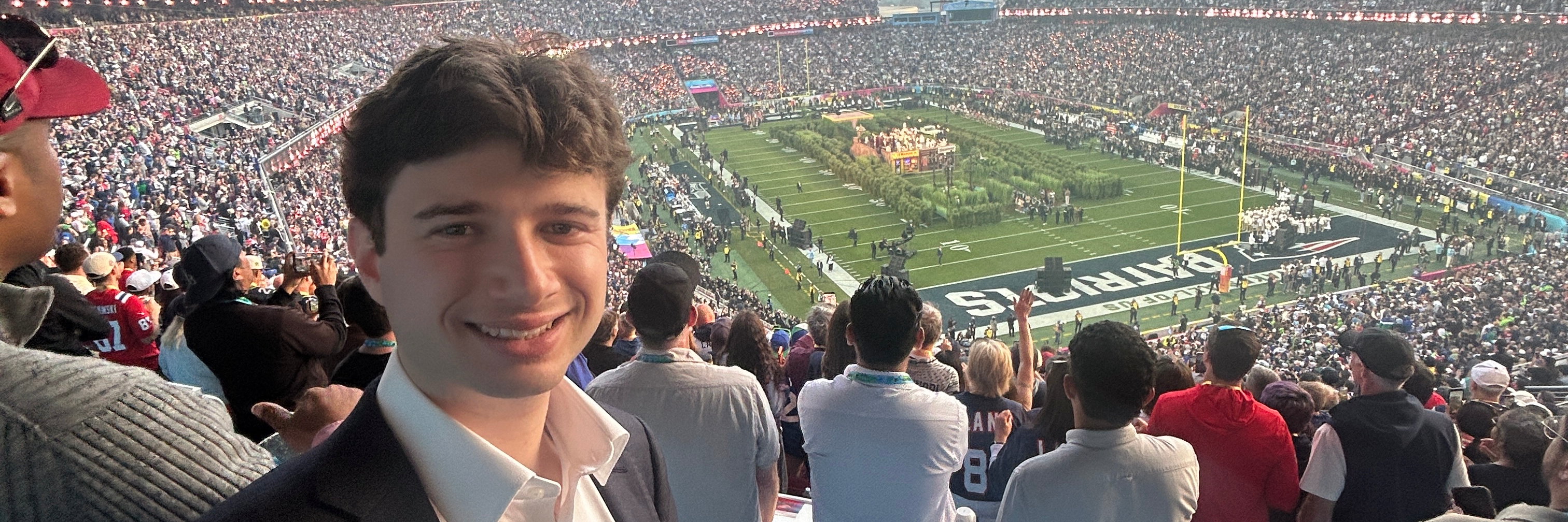 Harrison Rich smiles with Super Bowl LX field behind him at Levi's Stadium in Santa Clara, California